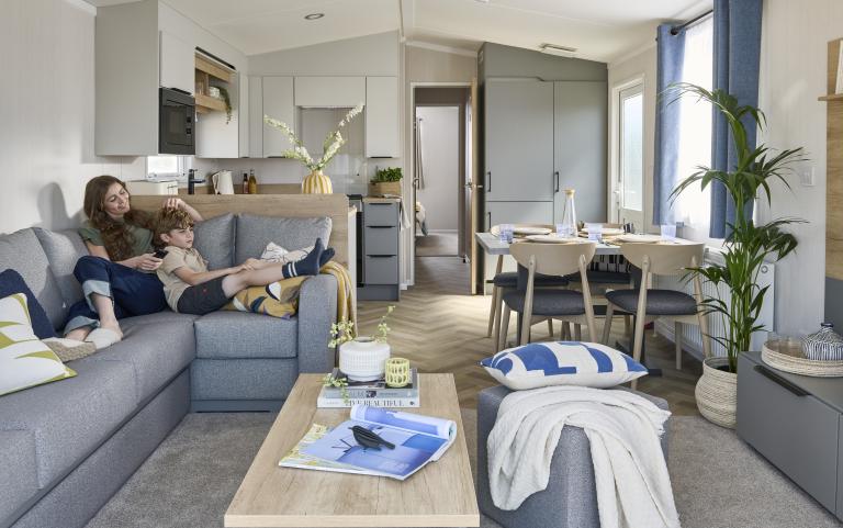 Mother and son relaxing in the living area of their holiday home