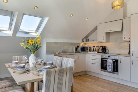 the kitchen and dining area in the Beachcomber apartment 