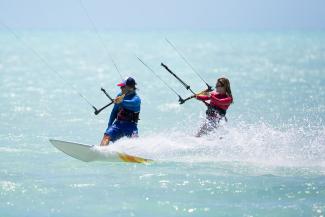 Couple kitesurfing in the sea